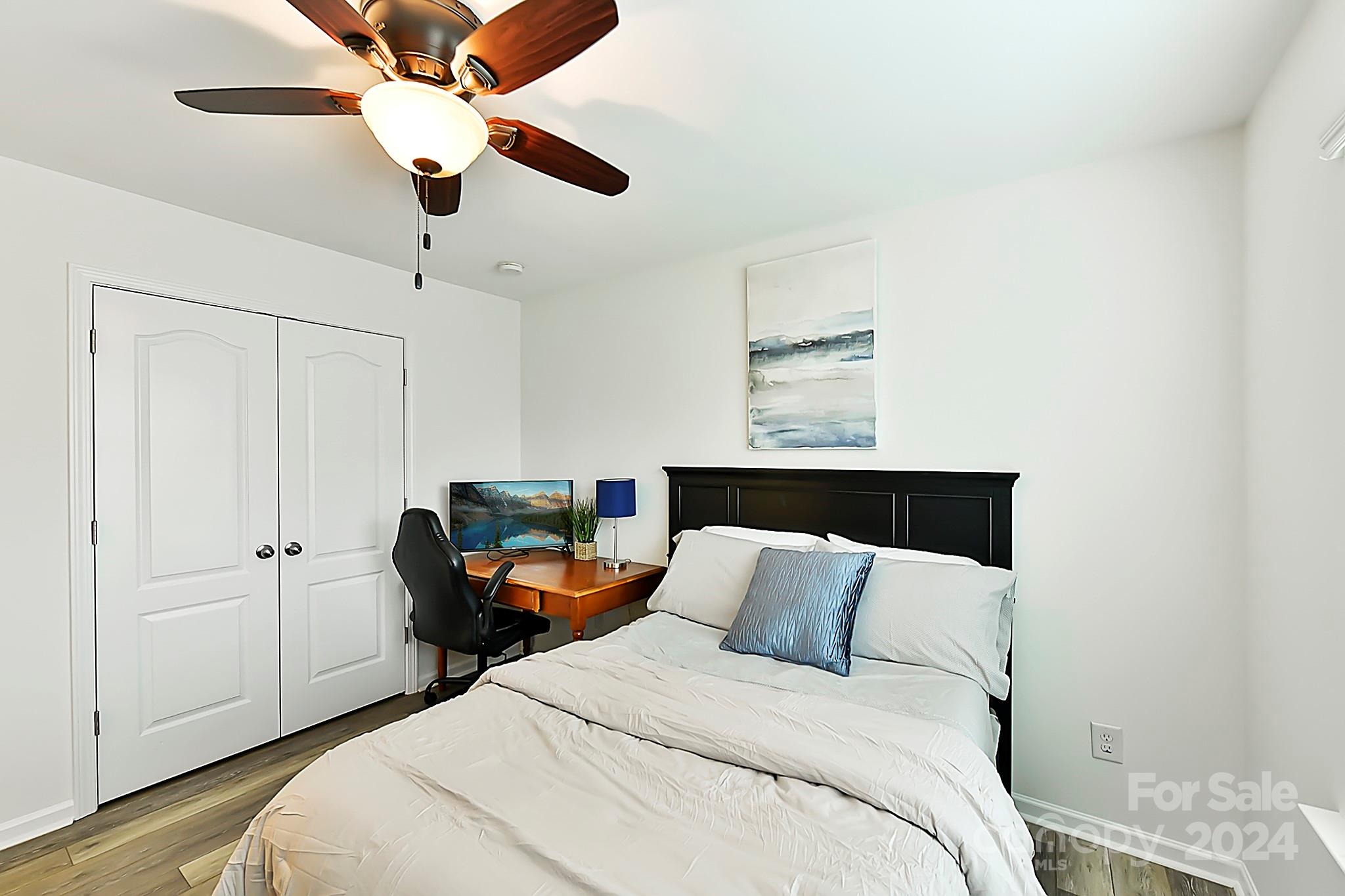 1201 Screech Owl Road Waxhaw, NC 28173 - Photo 27 of 43 a bed room with a bed and a ceiling fan