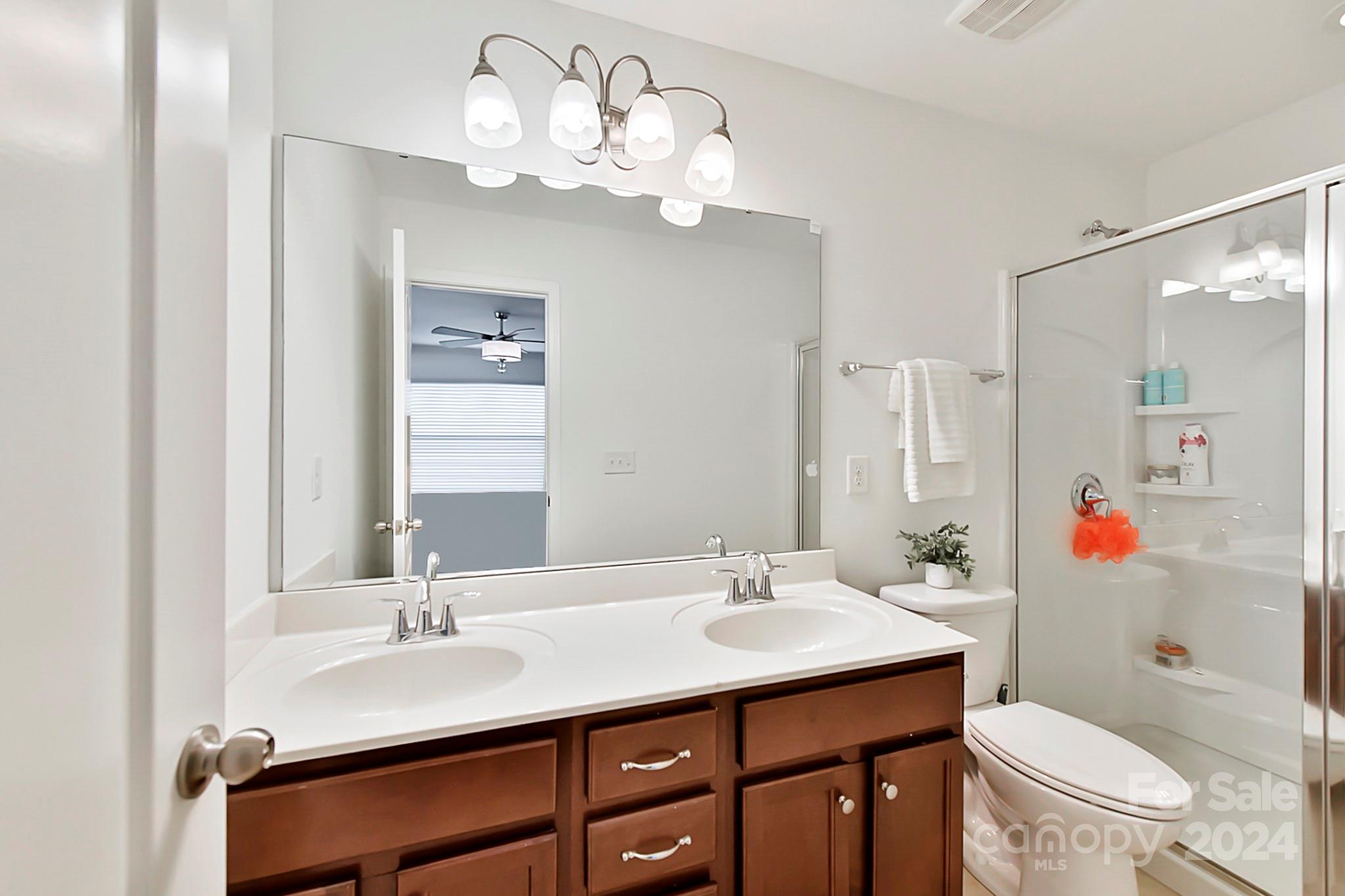 1201 Screech Owl Road Waxhaw, NC 28173 - Photo 36 of 43 a bathroom with a sink a toilet and a mirror