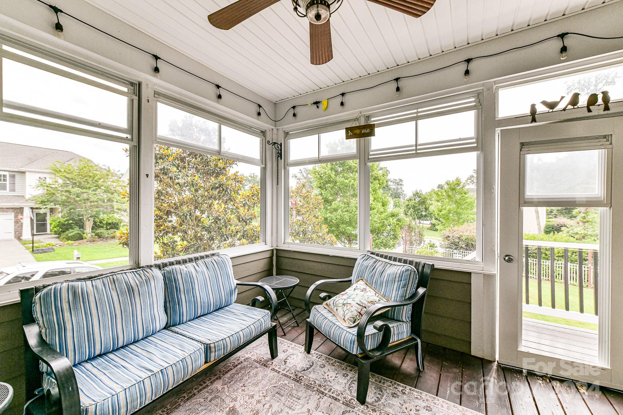1201 Screech Owl Road Waxhaw, NC 28173 - Photo 37 of 43 a living room with furniture and a floor to ceiling window