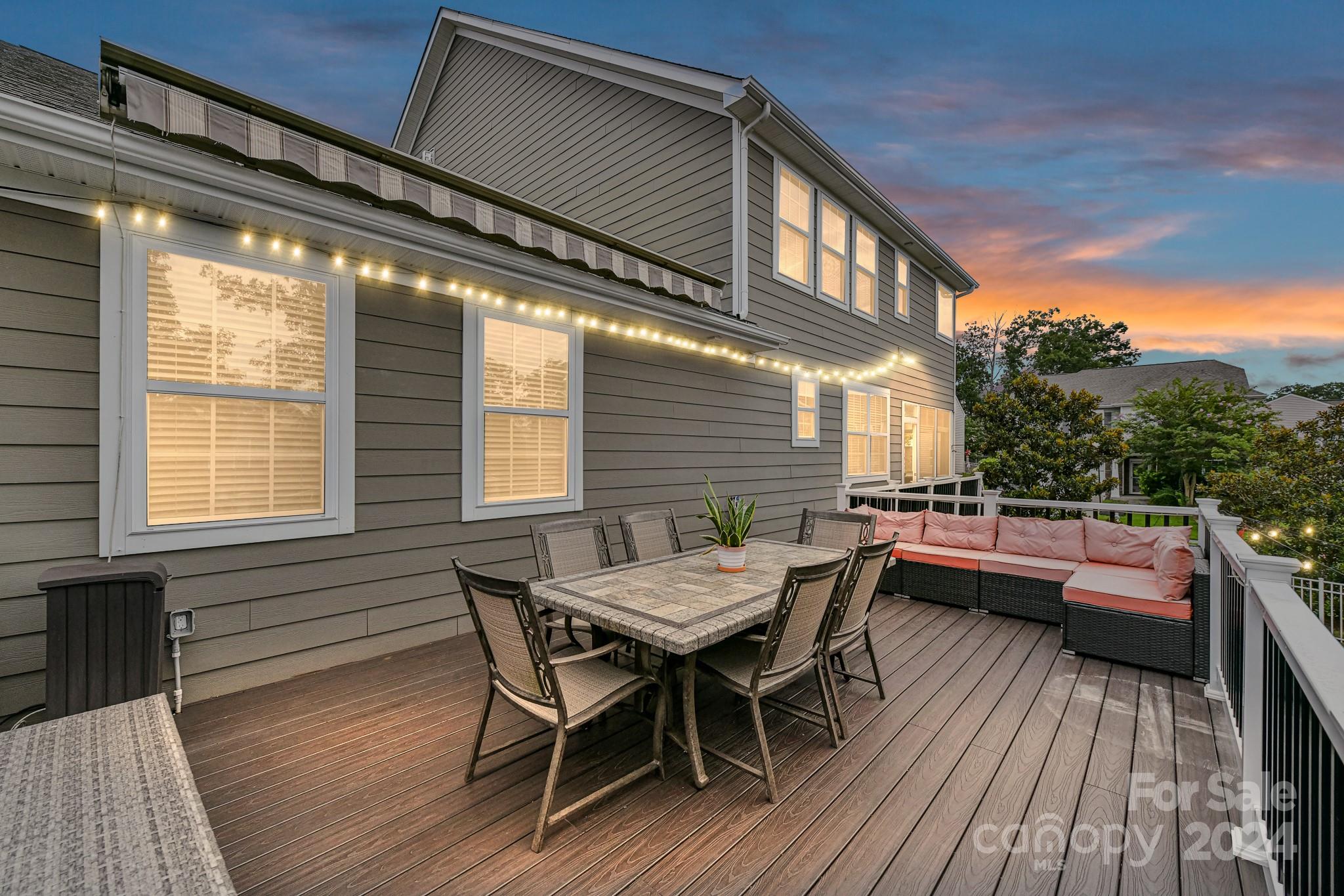 1201 Screech Owl Road Waxhaw, NC 28173 - Photo 39 of 43 a view of a roof deck with table and chairs and wooden floor