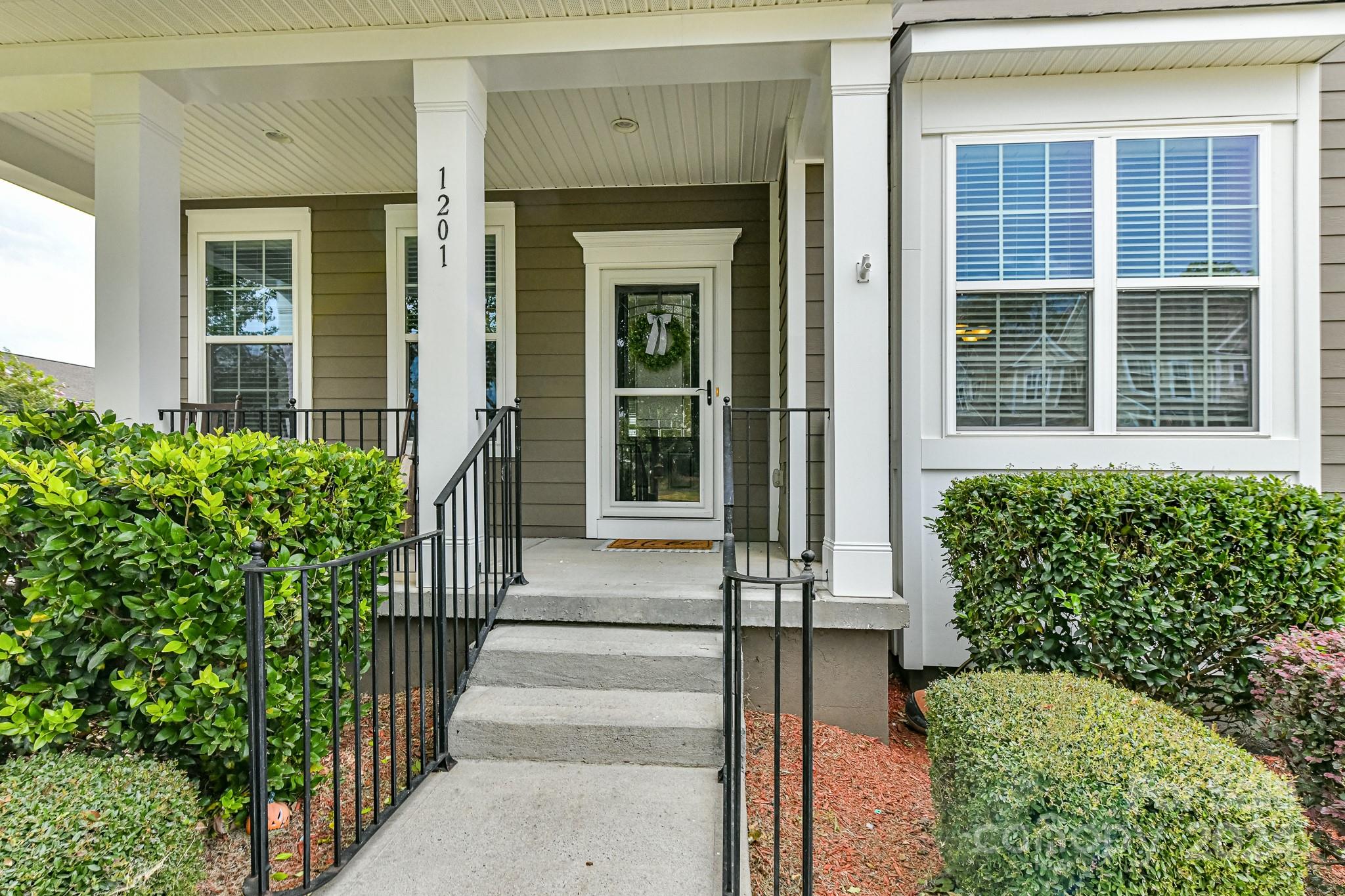 1201 Screech Owl Road Waxhaw, NC 28173 - Photo 4 of 43 a front view of a house with a garden