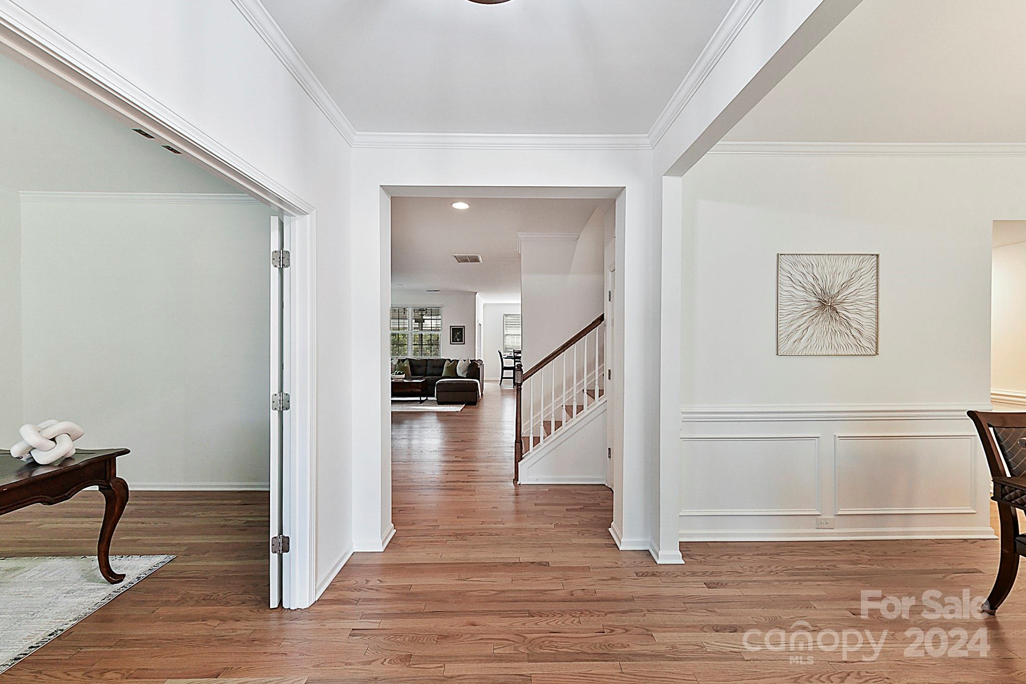 1201 Screech Owl Road Waxhaw, NC 28173 - Photo 6 of 43 a view of a hallway with wooden floor and staircase