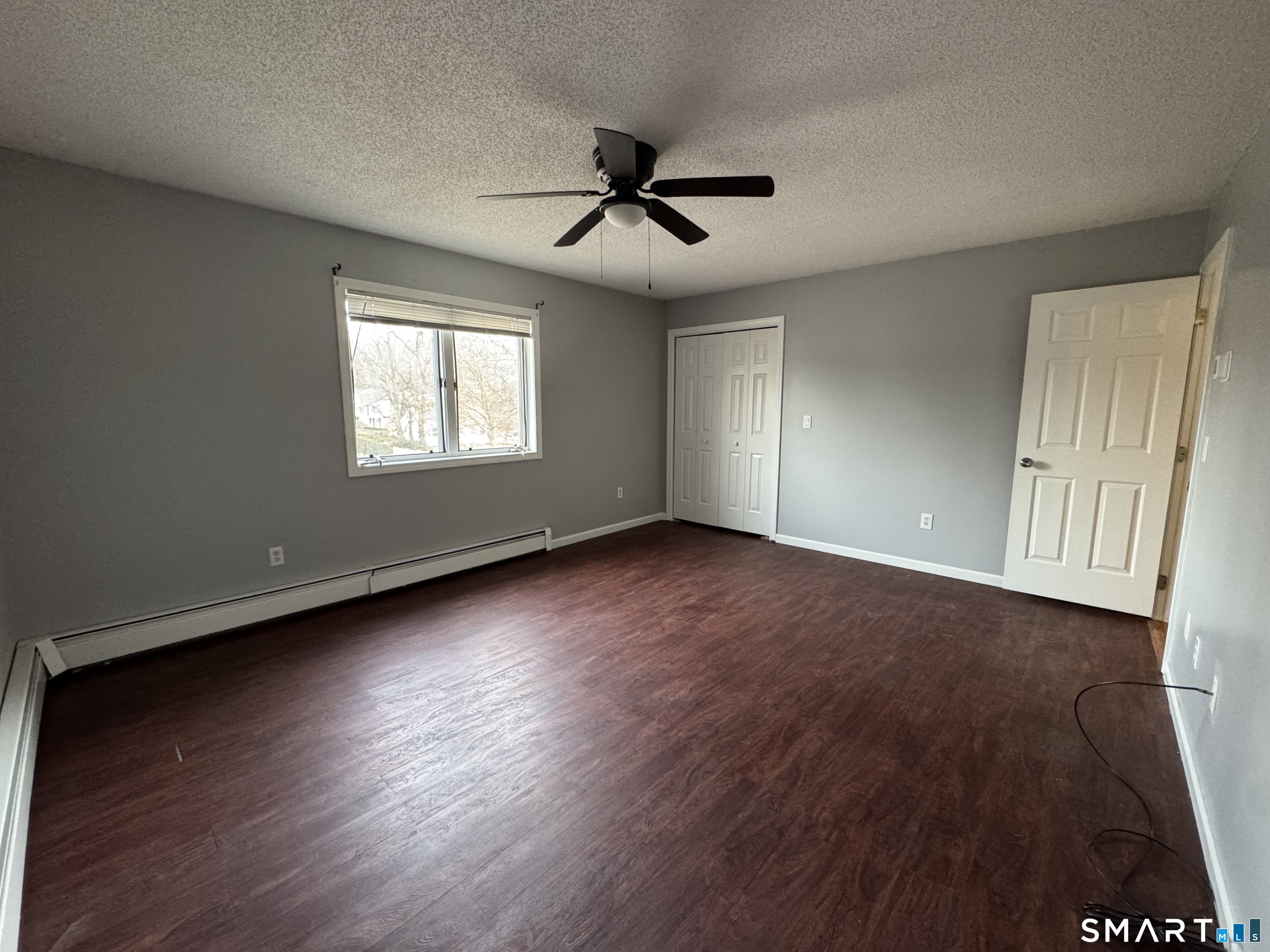 27 Katie Lane Waterbury, CT 06708 - Photo 8 of 14 an empty room with wooden floor and windows