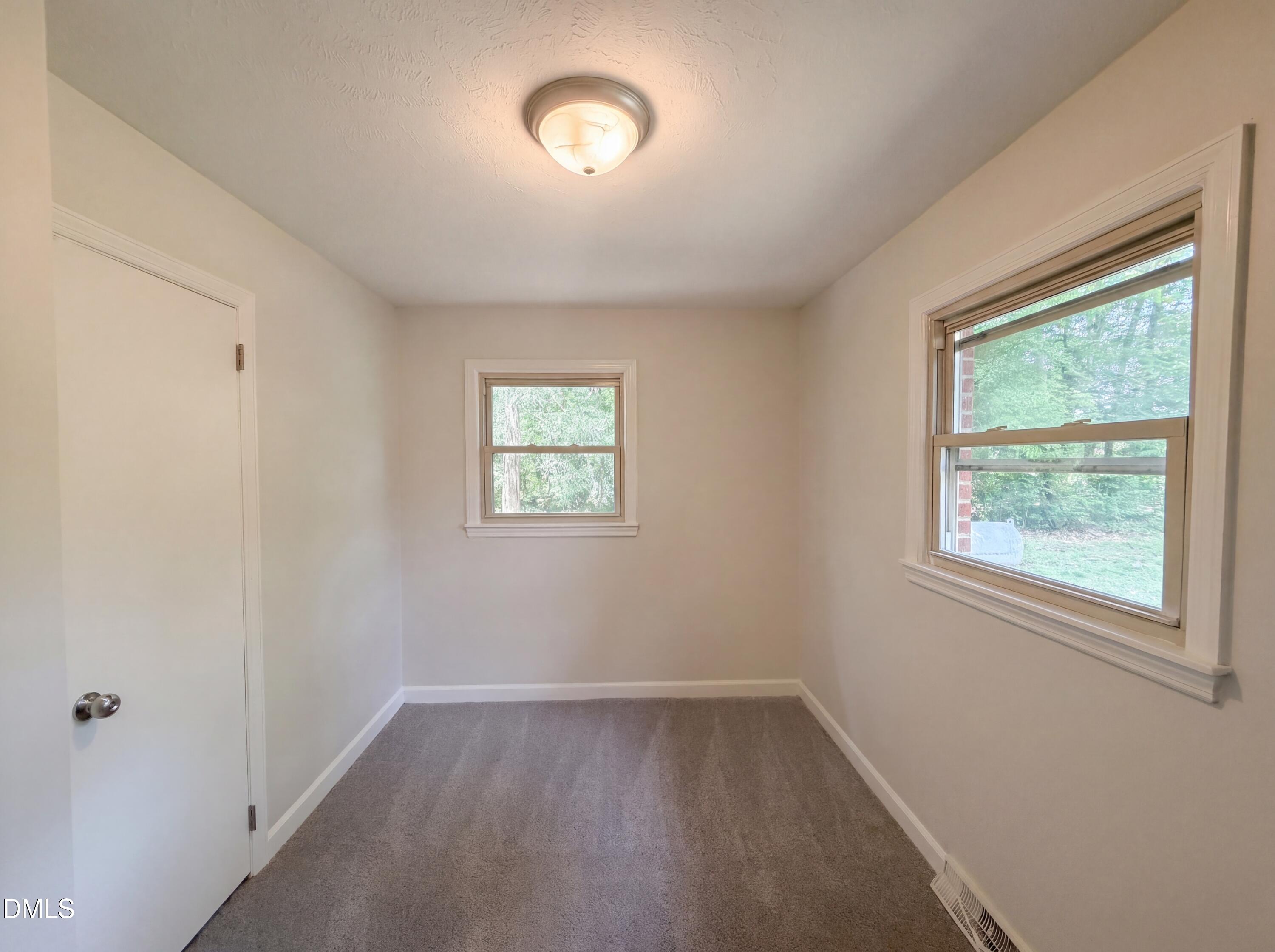 1710 West B Street Butner, NC 27509 - Photo 8 of 14 an empty room with a window