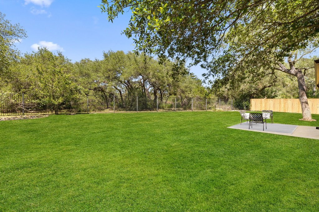 11129 Bastogne Loop Austin, TX 78739 - Photo 2 of 40 Room for a pool, greenbelt privacy, large oak trees, and enough grass for soccer games, sprinkler runs, and dogs living their best lives.