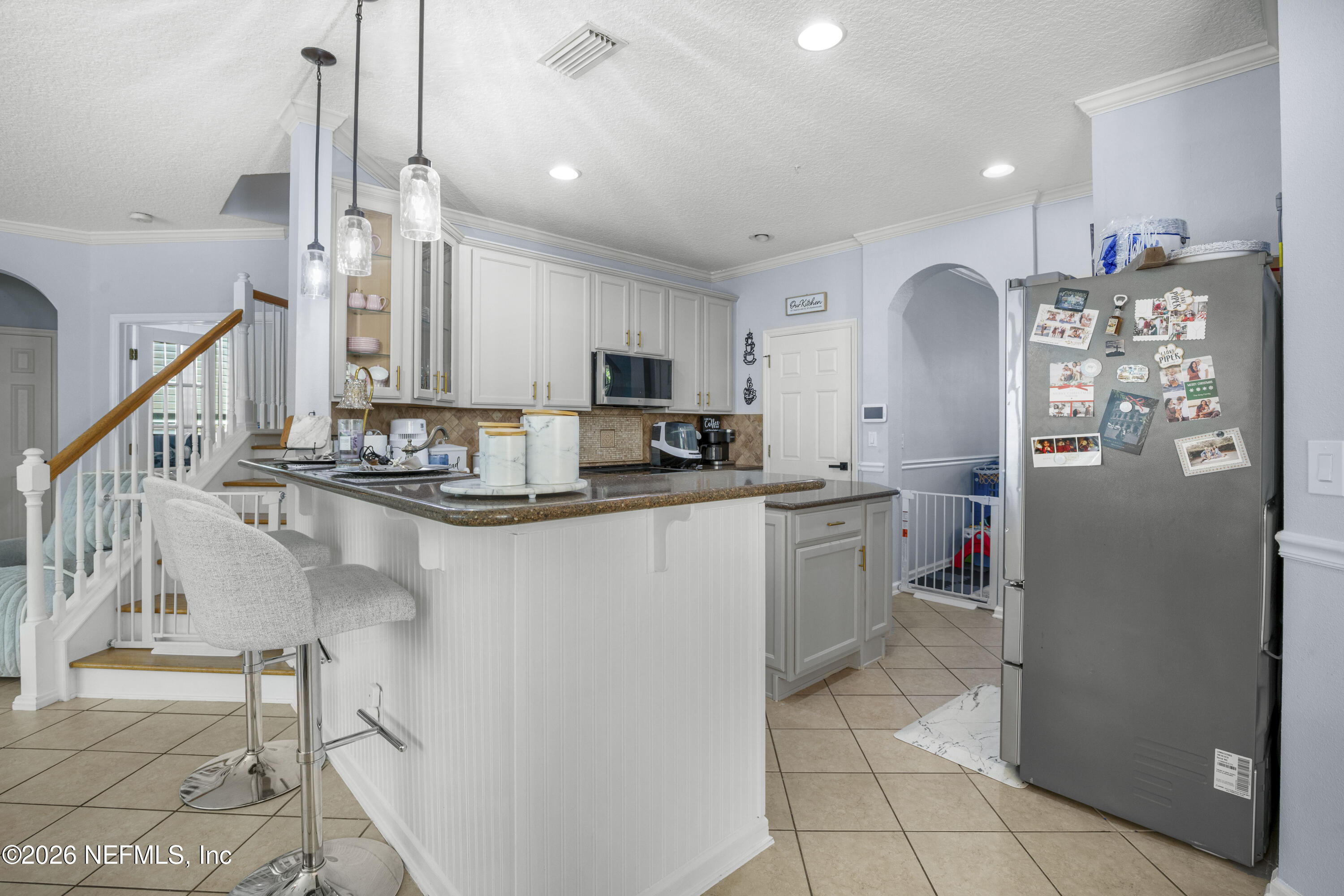 3020 South Atherley Road St. Augustine, FL 32092 - Photo 15 of 61 a kitchen with refrigerator and cabinets