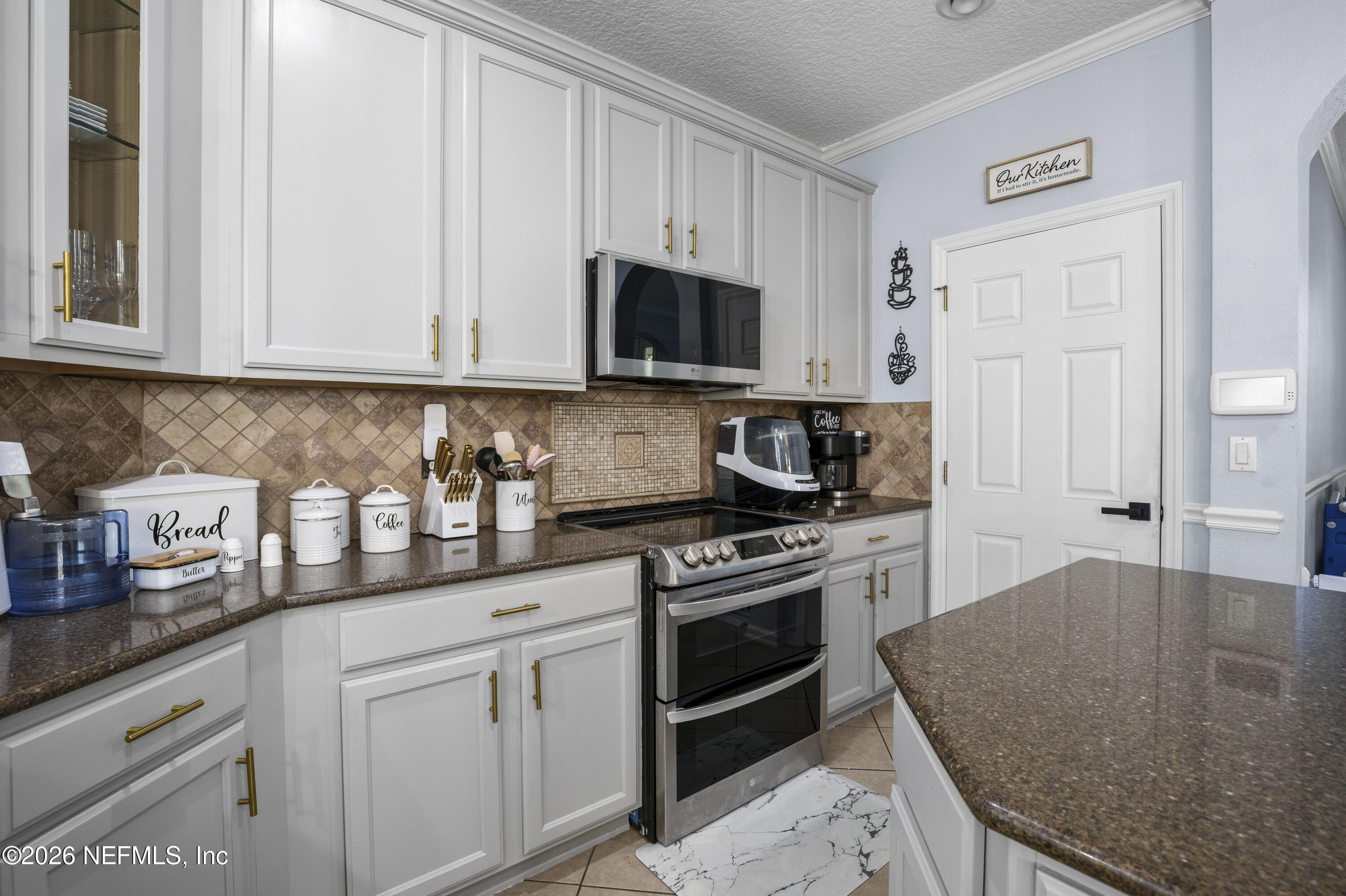 3020 South Atherley Road St. Augustine, FL 32092 - Photo 17 of 61 a kitchen with stainless steel appliances granite countertop a sink a stove and a refrigerator