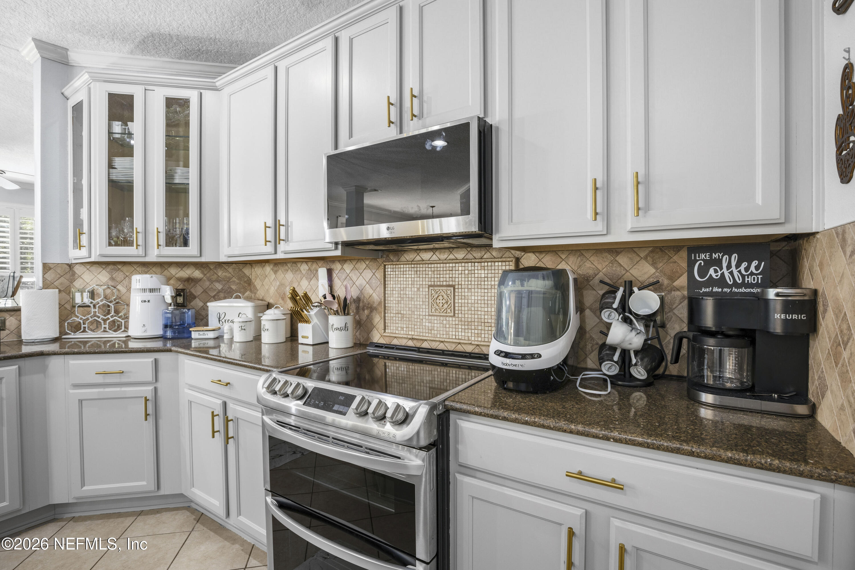 3020 South Atherley Road St. Augustine, FL 32092 - Photo 19 of 61 a kitchen with granite countertop a stove a sink and a microwave