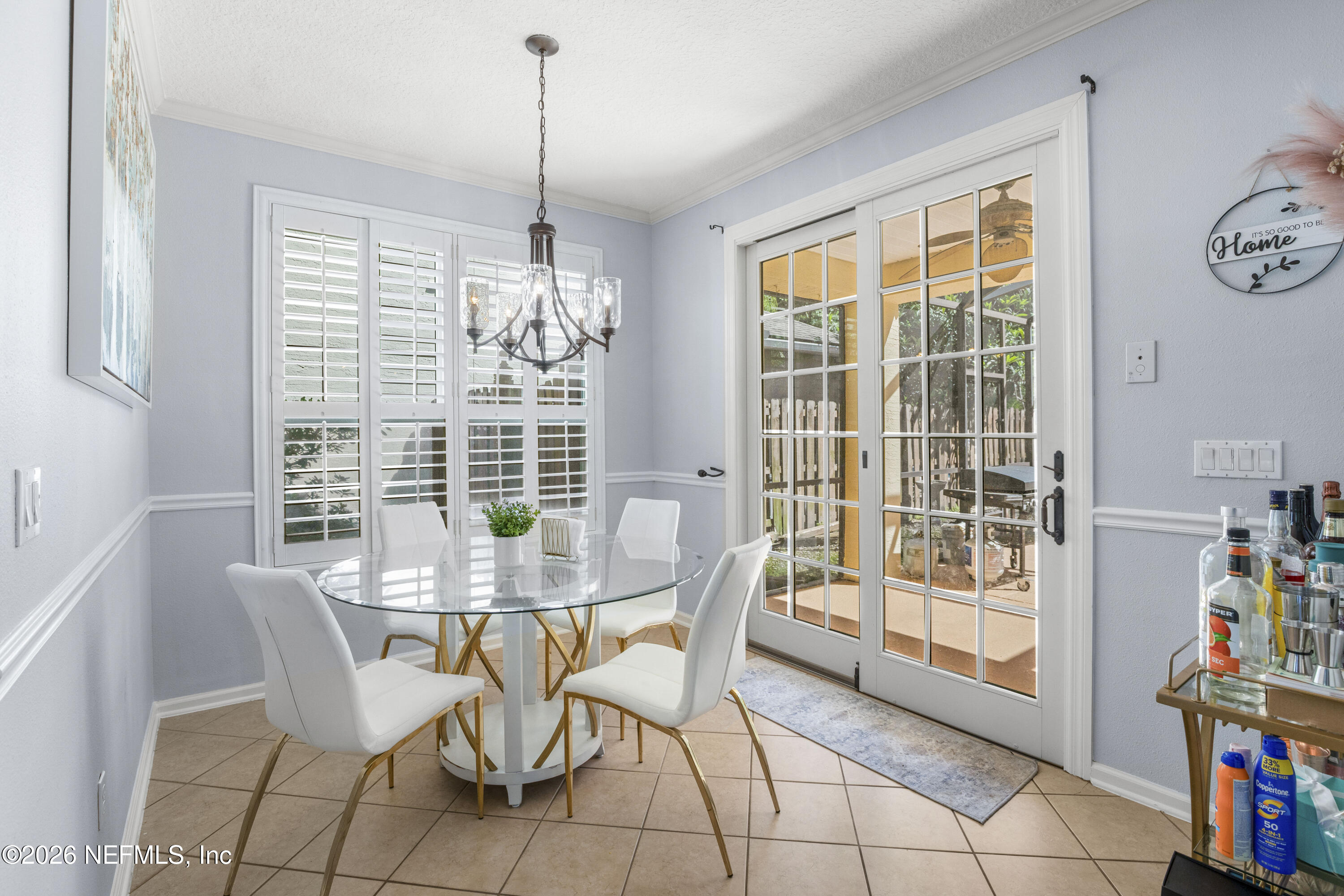 3020 South Atherley Road St. Augustine, FL 32092 - Photo 21 of 61 a dining room with furniture a chandelier and wooden floor
