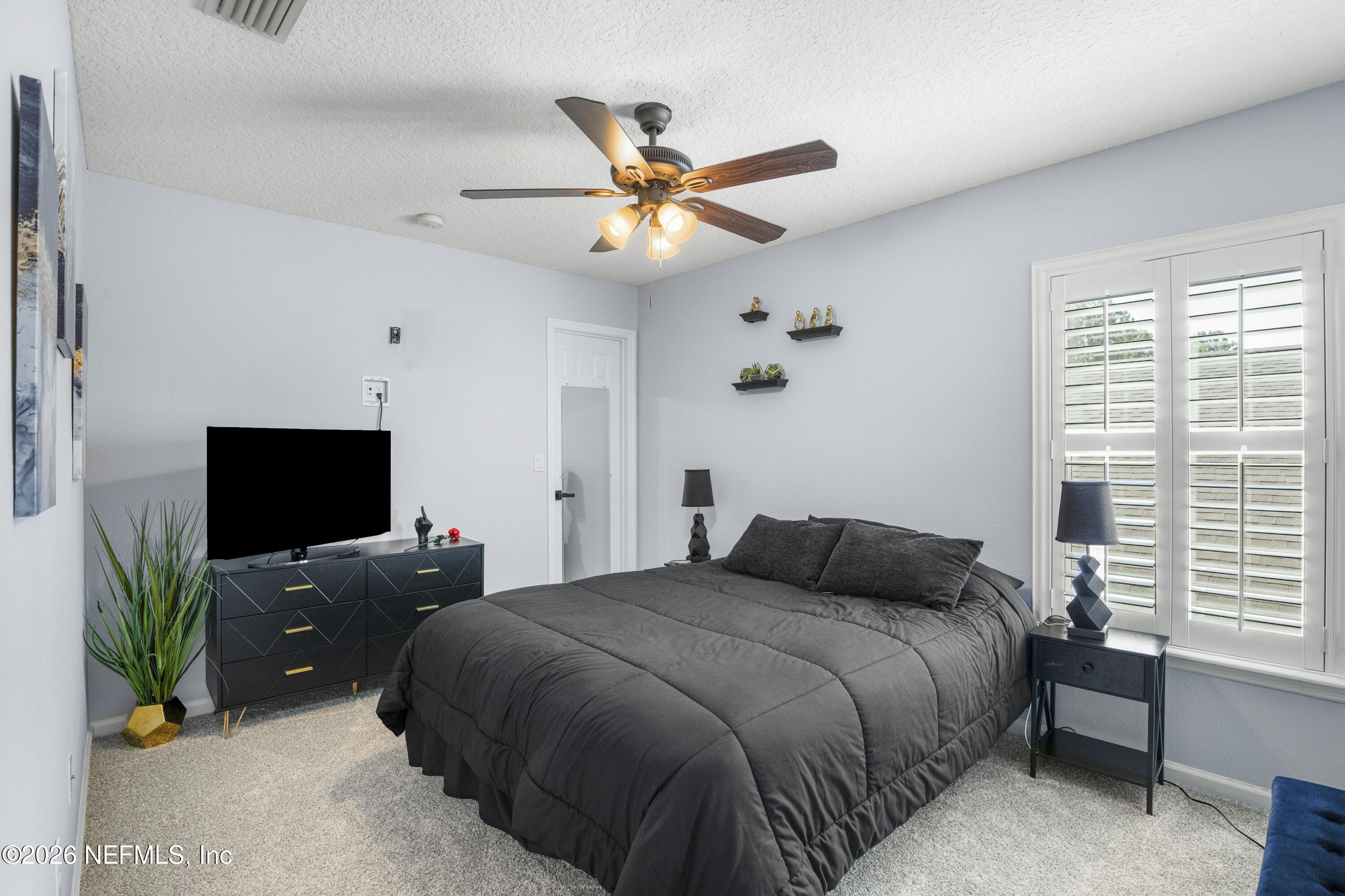 3020 South Atherley Road St. Augustine, FL 32092 - Photo 28 of 61 a bedroom with a bed window and a flat screen tv