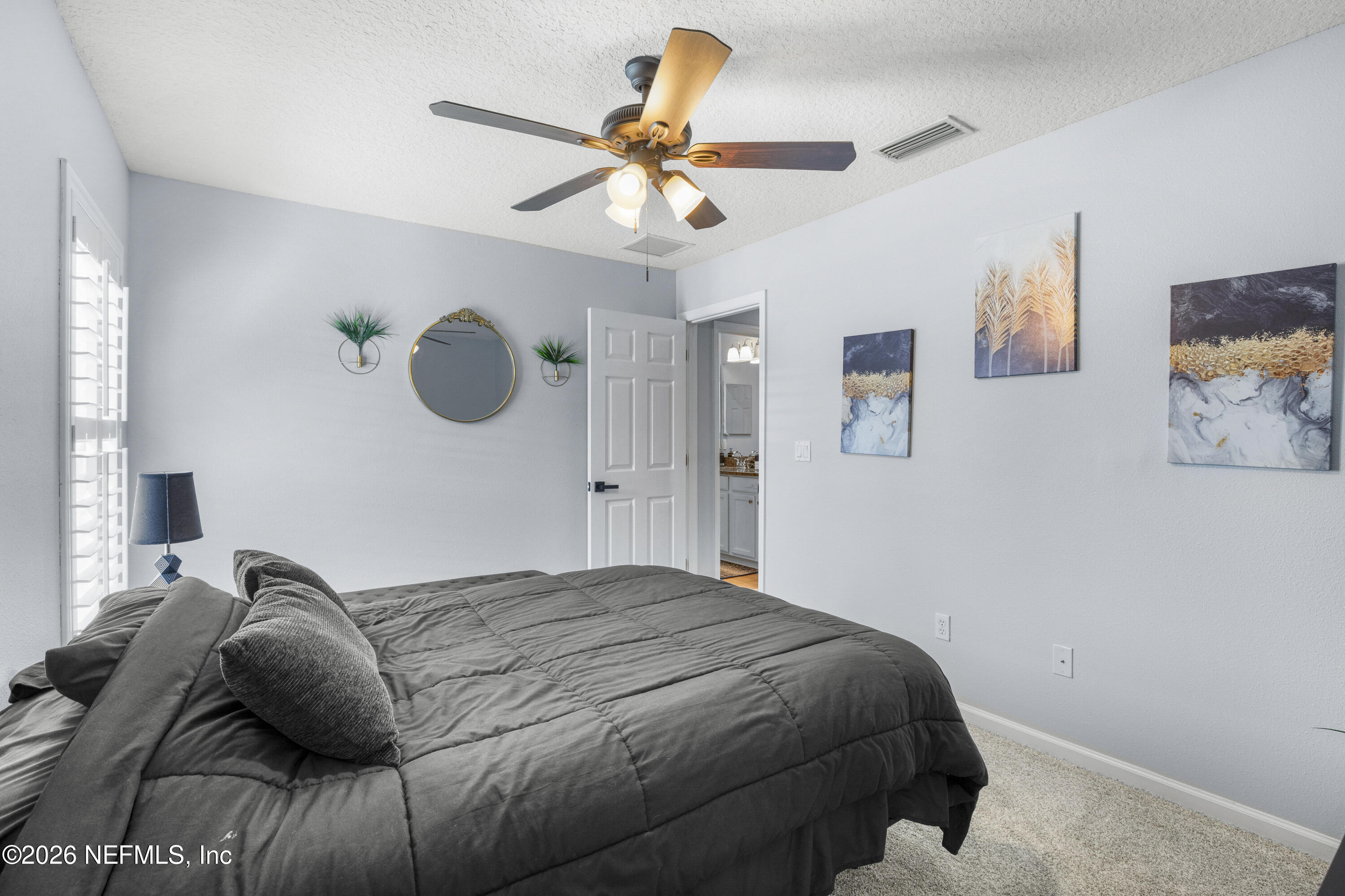 3020 South Atherley Road St. Augustine, FL 32092 - Photo 29 of 61 a bedroom with a bed and a chandelier