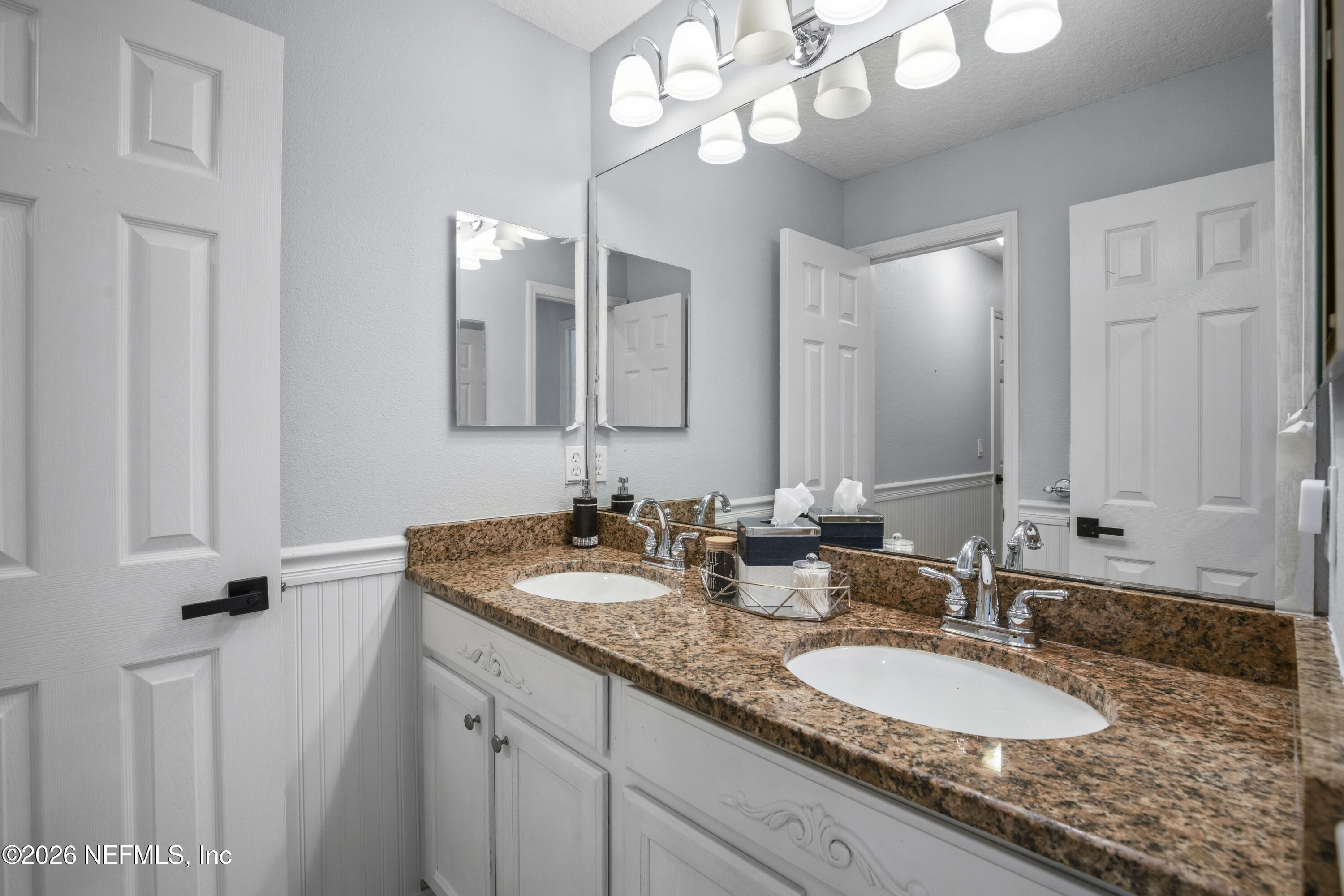 3020 South Atherley Road St. Augustine, FL 32092 - Photo 30 of 61 a bathroom with a granite countertop double vanity sinks a vanity and a mirror