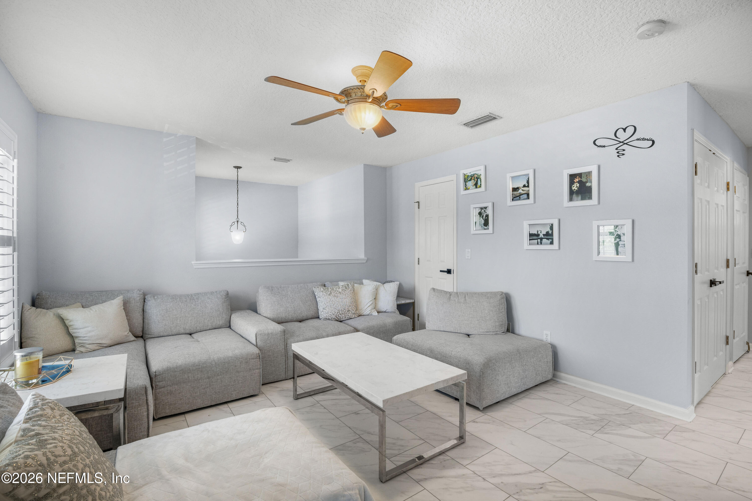 3020 South Atherley Road St. Augustine, FL 32092 - Photo 35 of 61 a living room with furniture and kitchen view