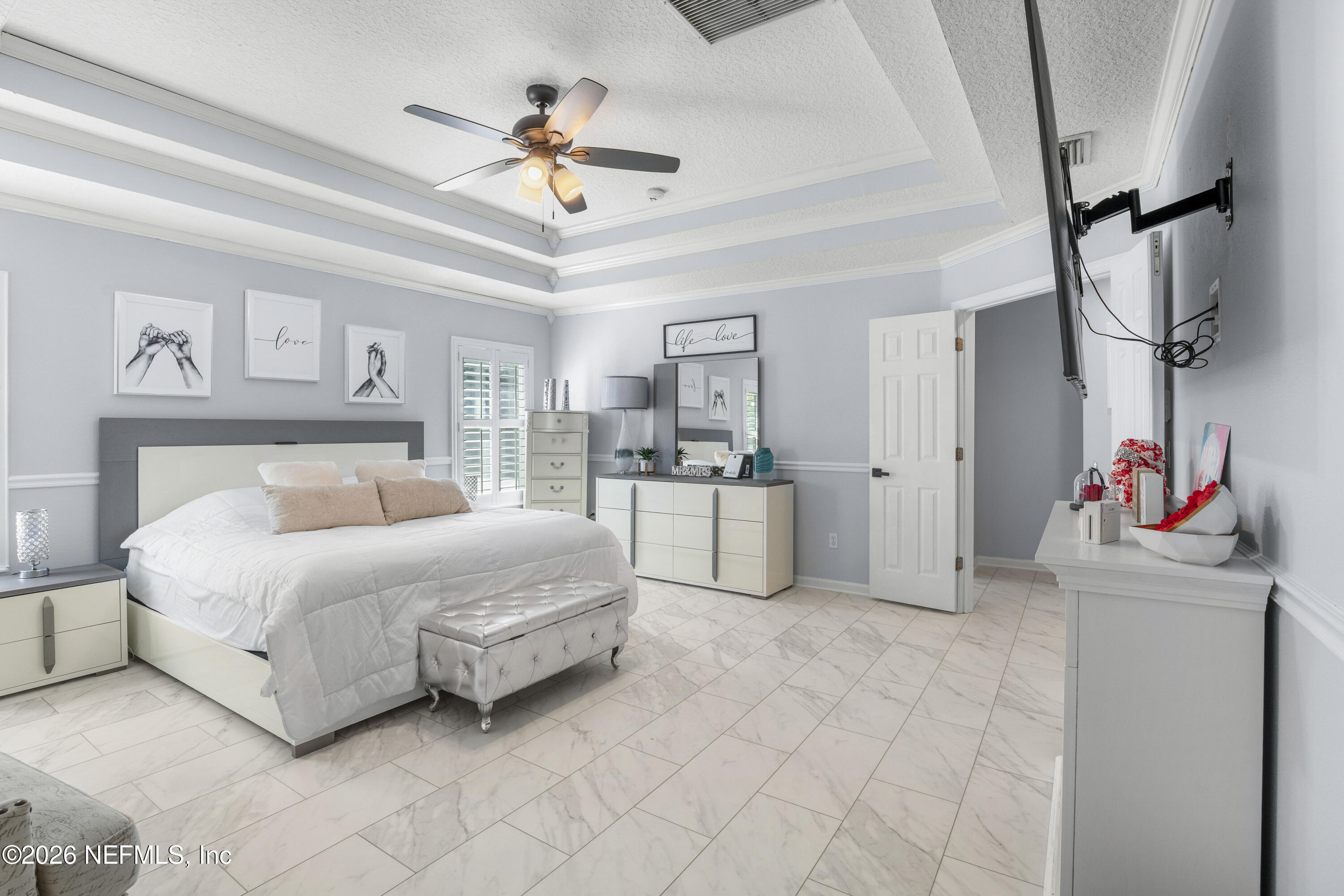 3020 South Atherley Road St. Augustine, FL 32092 - Photo 38 of 61 a spacious bedroom with a bed closet and flat screen tv