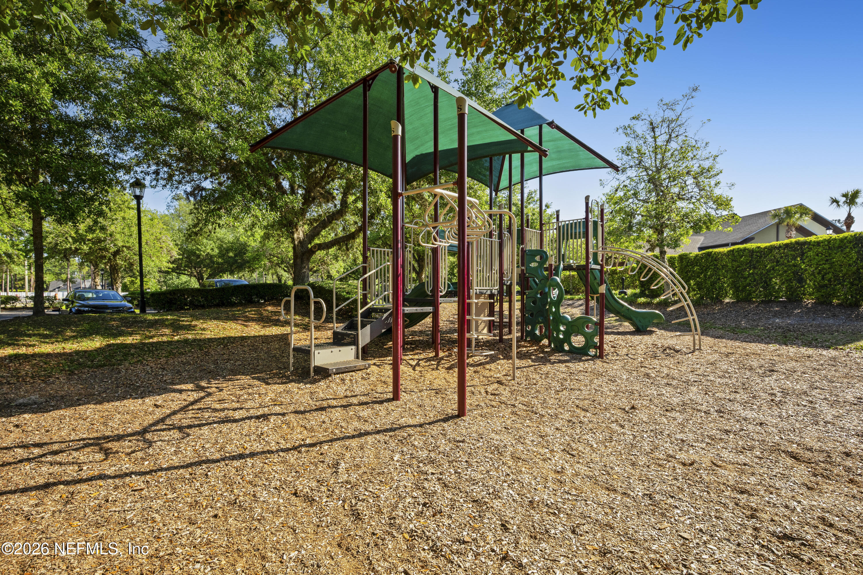 3020 South Atherley Road St. Augustine, FL 32092 - Photo 58 of 61 a view of a park with swings and slides