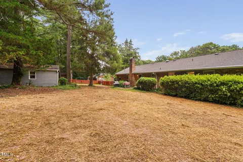 an aerial view of a house with garden space and a lake view