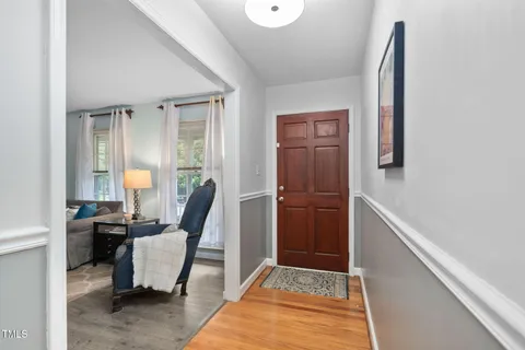 a view of a hallway with wooden floor and closet