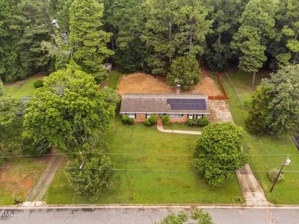 a front view of house with yard along with trees
