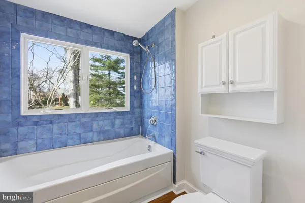 a bathroom with a bathtub and window