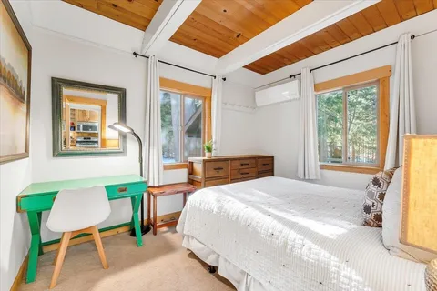 a bedroom with a bed a table and chair