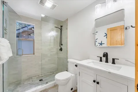 a bathroom with a sink toilet and shower