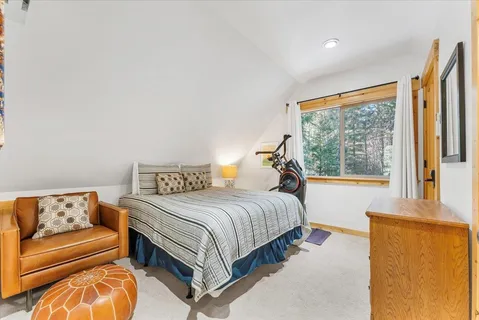 a bedroom with a bed and glass window