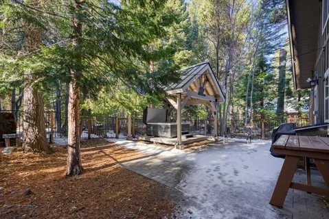 a backyard of a house with table and chairs