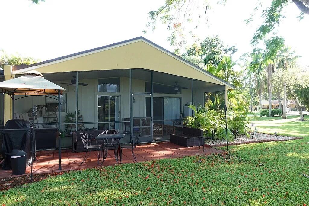 11720 Timbers Way Boca Raton, FL 33428 - Photo 3 of 19 a front view of a house with a yard table and chairs