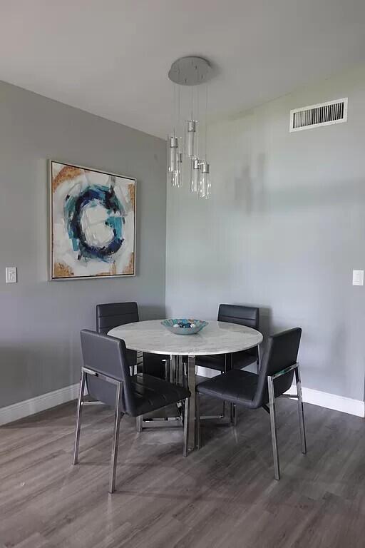 11720 Timbers Way Boca Raton, FL 33428 - Photo 6 of 19 a view of a dining room with furniture and wooden floor