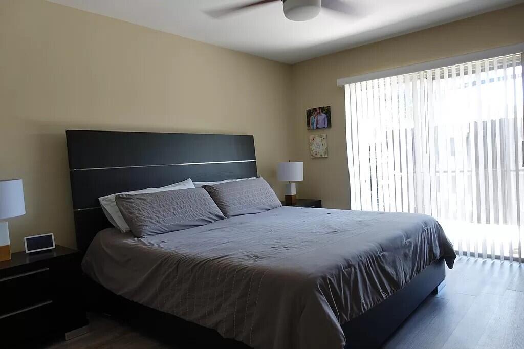 11720 Timbers Way Boca Raton, FL 33428 - Photo 9 of 19 a bedroom with a bed and window