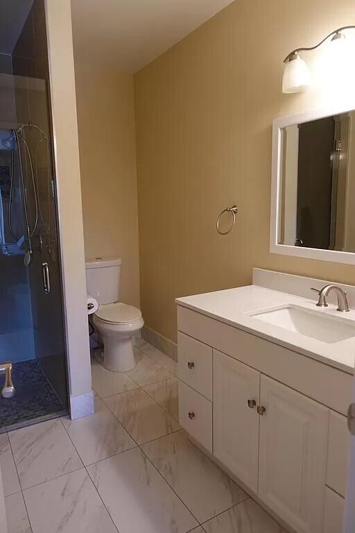11720 Timbers Way Boca Raton, FL 33428 - Photo 10 of 19 a bathroom with a sink and a toilet