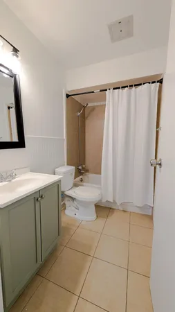 a bathroom with a sink a toilet and mirror