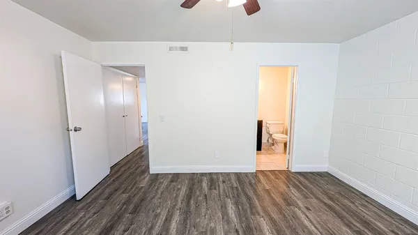 a view of an empty room with wooden floor