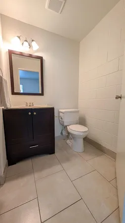 a bathroom with a toilet and a mirror