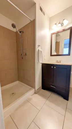 a bathroom with a tub sink and mirror