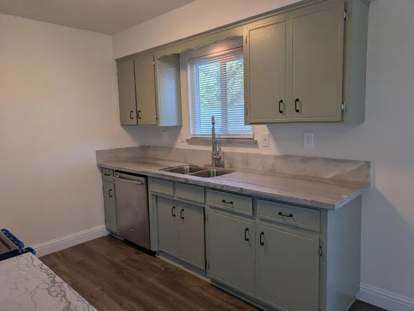 a hallway with a sink and a mirror