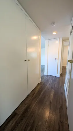 a view of hallway with wooden floor