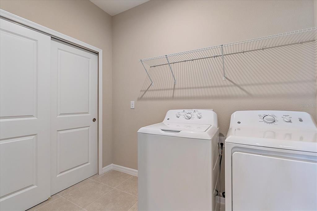 12410 Osorio Court, Unit 201 Sarasota, FL 34238 - Photo 18 of 42 a utility room with dryer and washer