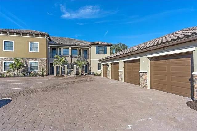 a front view of a house with glass windows and brick wall