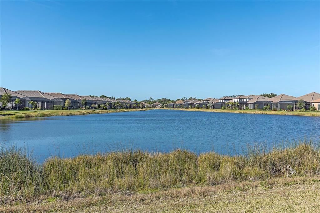 12410 Osorio Court, Unit 201 Sarasota, FL 34238 - Photo 22 of 42 a view of an ocean with boats and trees in the background