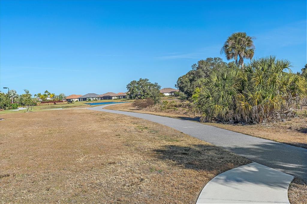 12410 Osorio Court, Unit 201 Sarasota, FL 34238 - Photo 23 of 42 a view of a large body of water with a building in the background