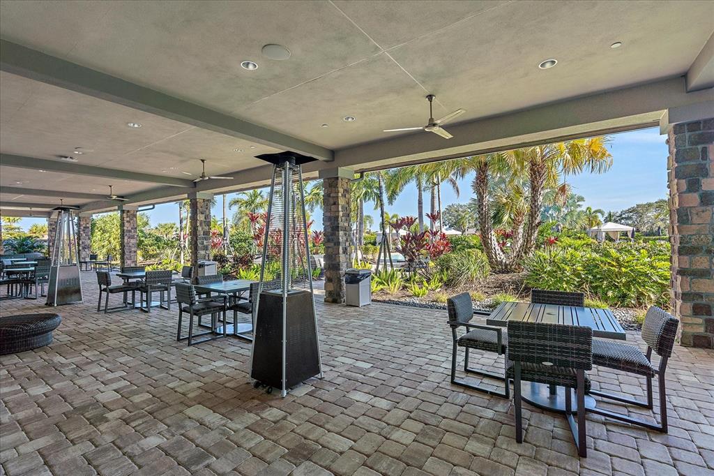 12410 Osorio Court, Unit 201 Sarasota, FL 34238 - Photo 28 of 42 a dining room with furniture and a floor to ceiling window