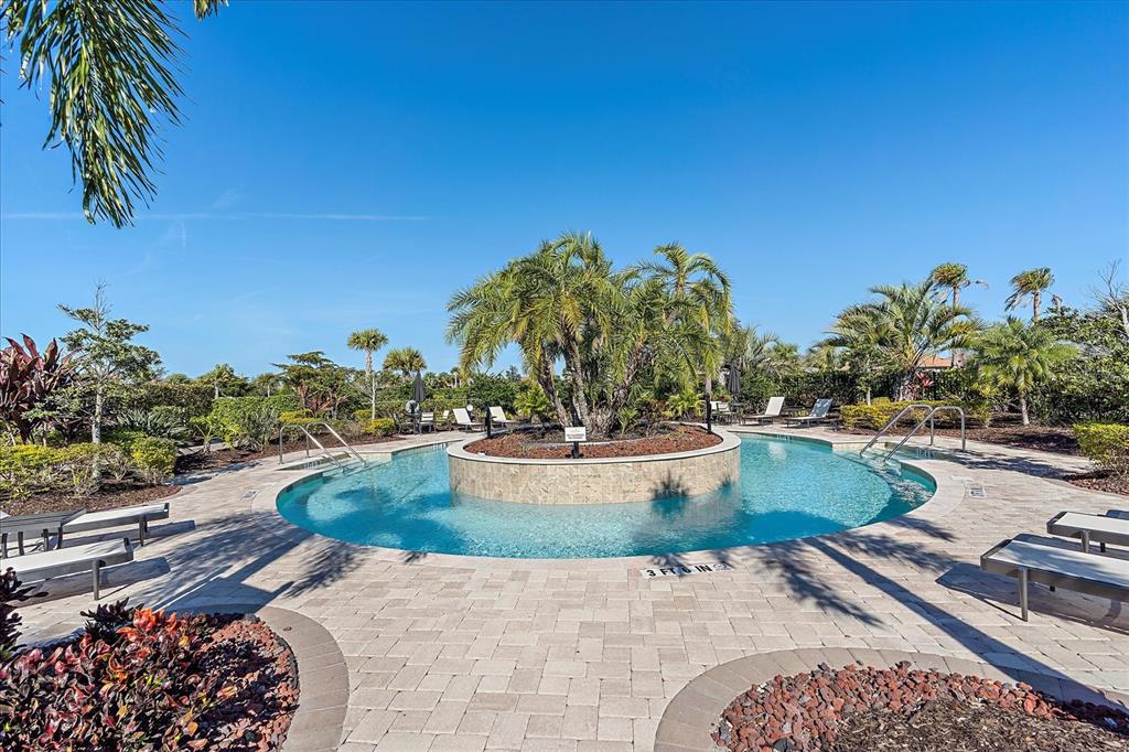 12410 Osorio Court, Unit 201 Sarasota, FL 34238 - Photo 31 of 42 a view of a swimming pool with a yard