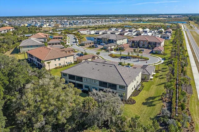 an aerial view of a residential apartment building with a yard