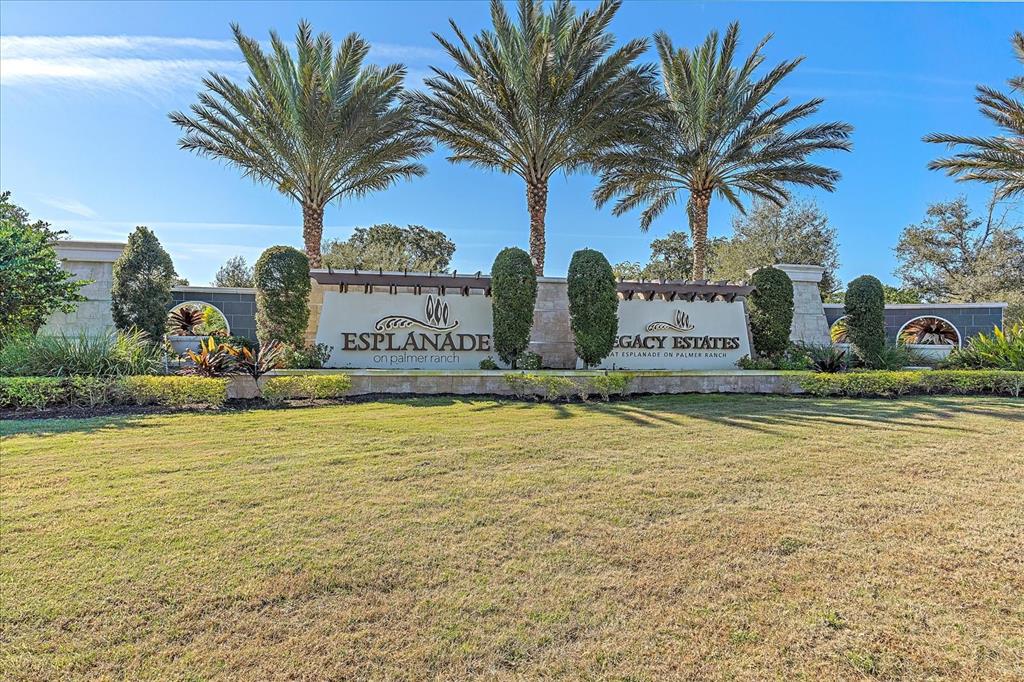 12410 Osorio Court, Unit 201 Sarasota, FL 34238 - Photo 39 of 42 a house with palm trees in front of it