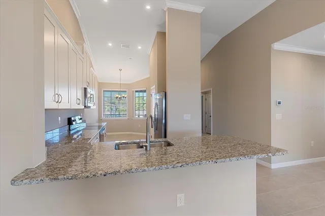 a kitchen with kitchen island granite countertop a sink and a counter top space