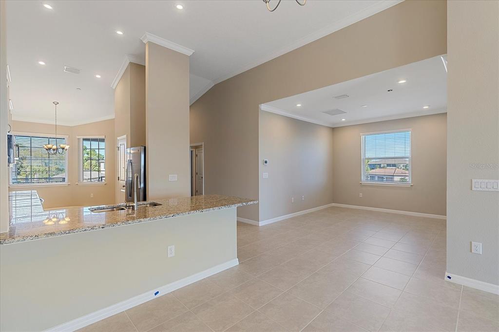 12410 Osorio Court, Unit 201 Sarasota, FL 34238 - Photo 8 of 42 an empty room with large windows