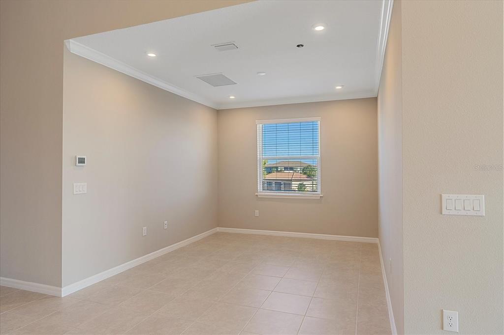 12410 Osorio Court, Unit 201 Sarasota, FL 34238 - Photo 9 of 42 an empty room with windows