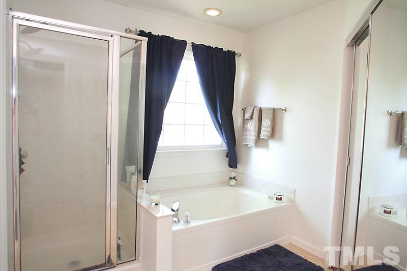 5501 Edgebury Road Raleigh, NC 27613 - Photo 11 of 14 a bathroom with a tub and a shower