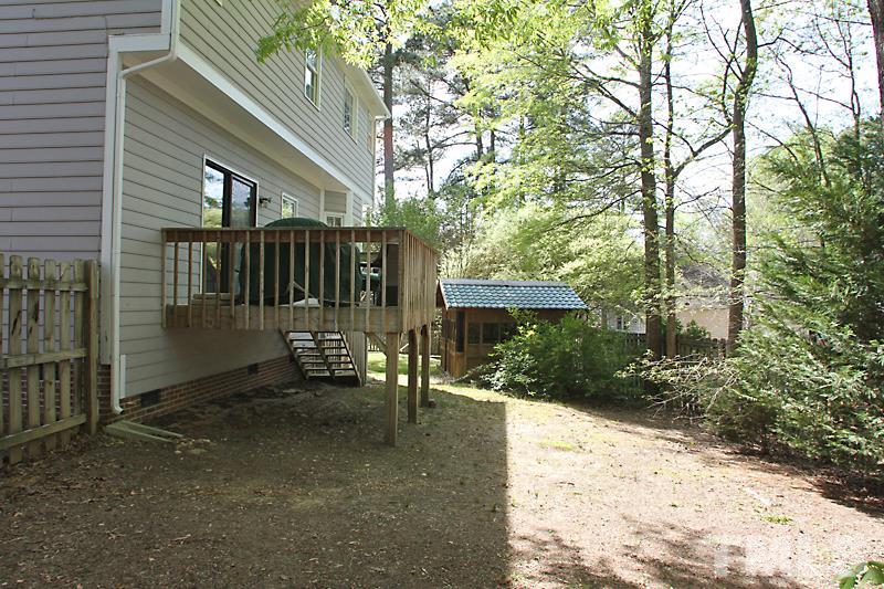 5501 Edgebury Road Raleigh, NC 27613 - Photo 13 of 14 a view of a patio with table and chairs and a large tree